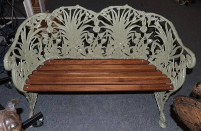 Lot 1220 - A reproduction lily pattern garden seat, with six wooden slats