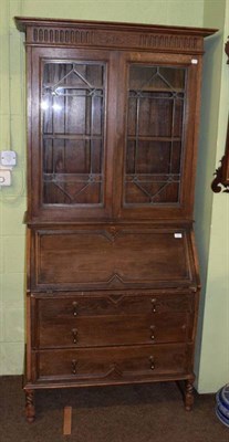 Lot 1241 - 1920s oak bureau bookcase with fitted interior and three drawers