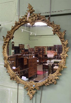 Lot 1242 - A modern plaster moulded mirror in the Rococo style