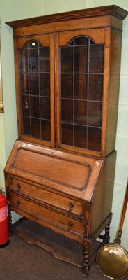 Lot 1247 - 1920s oak bureau bookcase, two drawers raised on barley twist legs