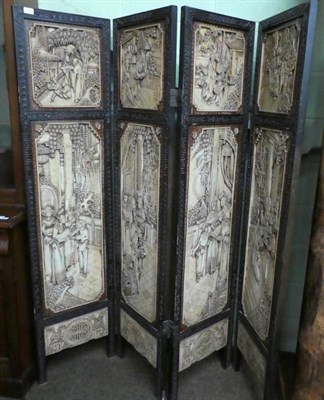 Lot 1250 - A 20th century Chinese heavily carved four-fold screen