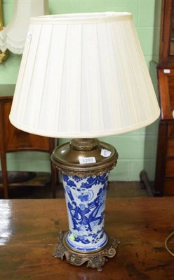 Lot 1293 - A Chinese blue and white table lamp with gilt metal mounts and a silk shade