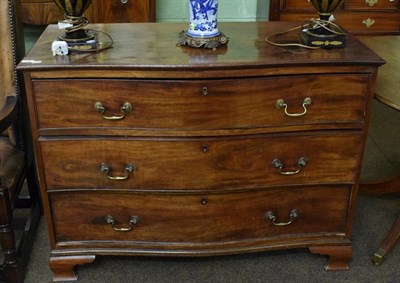 Lot 1297 - A George III mahogany serpentine fronted three height chest of drawers