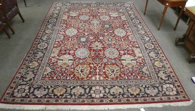 Lot 1317 - Good European machine made carpet of Agra design, the brick red field with an allover design of...