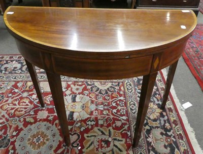 Lot 1318 - A 19th century mahogany and inlaid demi lune fold-over tea table