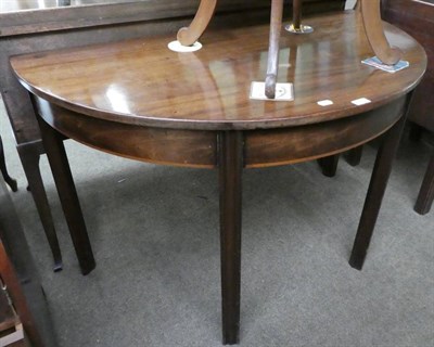 Lot 1334 - A late George III mahogany demi lune side table