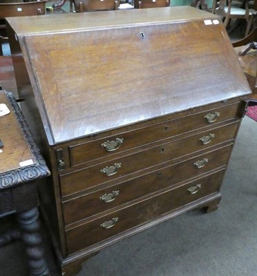 Lot 1341 - A George III oak bureau