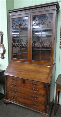 Lot 1366 - A reproduction mahogany bureau bookcase in George III style