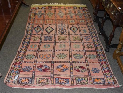 Lot 1225 - Berber rug, the abrashed compartmentalised field of geometric motifs enclosed by reciprocal...