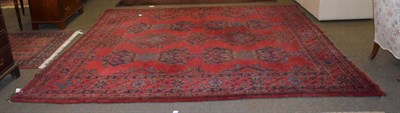 Lot 1226 - Ushak carpet of unusual size, the soft tomato red field with columns of medallions enclosed by...