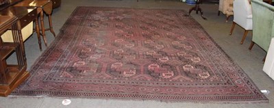 Lot 1227 - Afghan Turkman carpet, circa 1900, the field  with columns of elephant foot guls enclosed by...