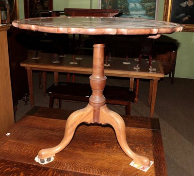 Lot 1394 - A 19th century mahogany piecrust top tripod table