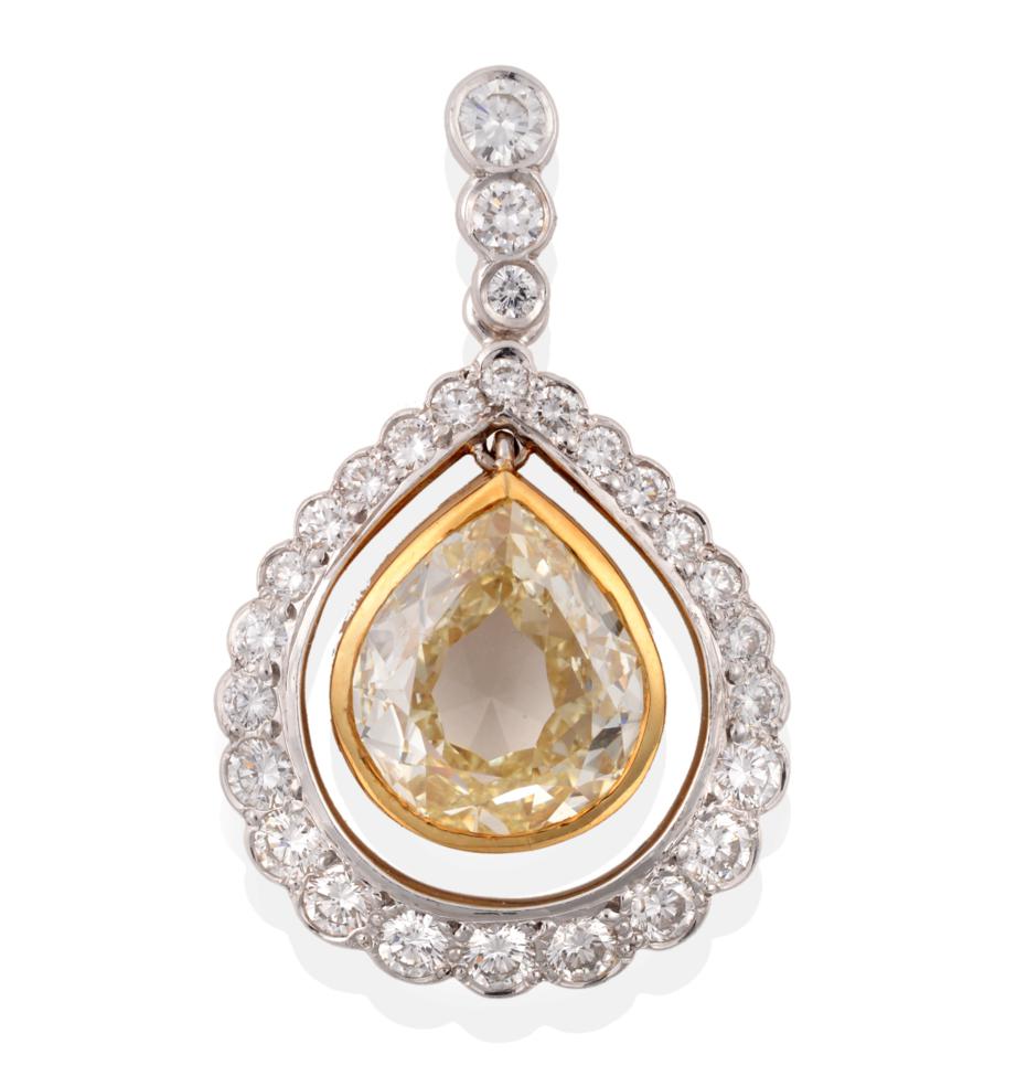 Lot 5 - A Yellow and White Diamond Cluster Pendant, a pear cut yellow diamond in a yellow rubbed over...