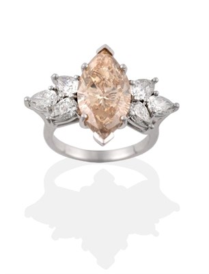 Lot 11 - A Fancy Diamond Ring, a light brown marquise cut diamond within two spray clusters of three...