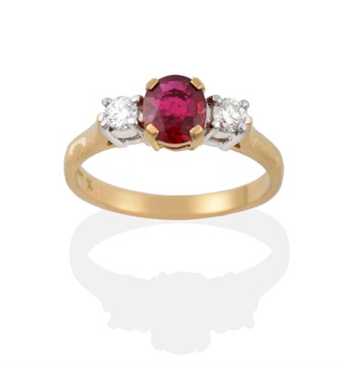 Lot 17 - An 18 Carat Gold Ruby and Diamond Three Stone Ring, the oval mixed cut ruby in a yellow claw...