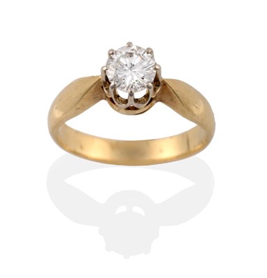 Lot 23 - A Diamond Solitaire Ring, the round brilliant cut diamond in a white claw setting, to a yellow...