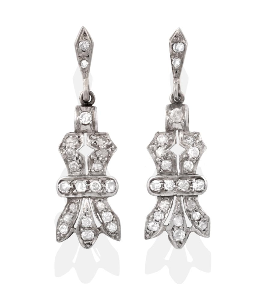 Lot 24 - A Pair of Diamond Drop Earrings, the panels of bow-like form set with eight-cut diamonds, total...