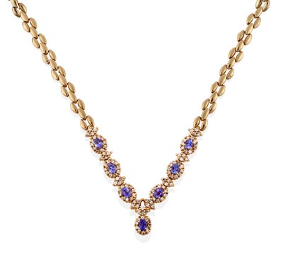 Lot 25 - A Tanzanite and Diamond Necklace, six clusters comprising an oval mixed cut tanzanite within a...