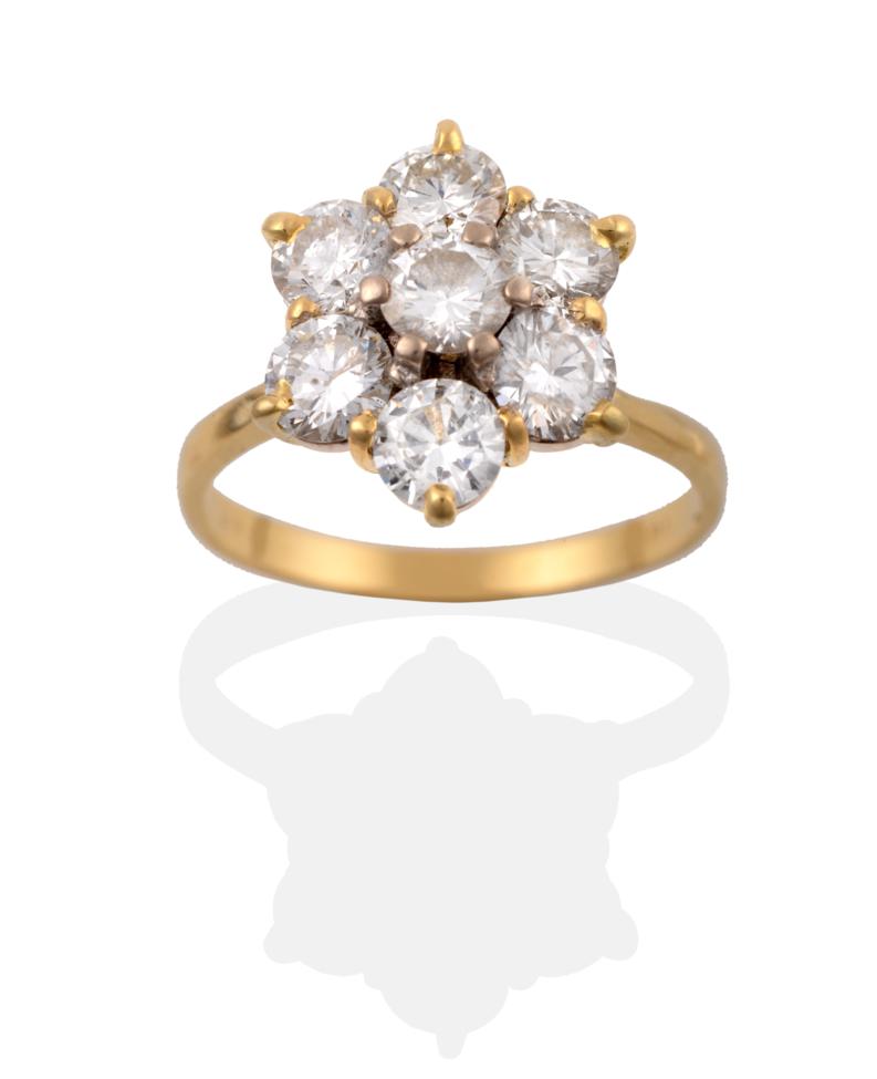 Lot 27 - A Diamond Cluster Ring, seven round brilliant cut diamonds in yellow claw settings, to a...