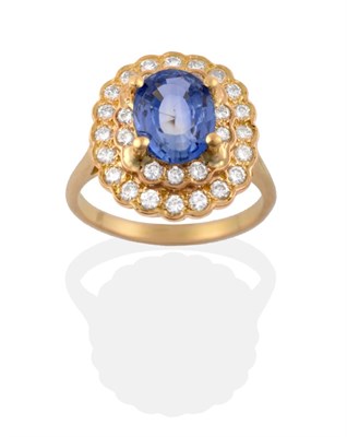 Lot 28 - A Sapphire and Diamond Cluster Ring, an oval mixed cut sapphire in a yellow four claw setting,...