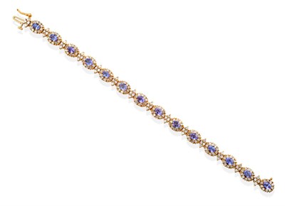 Lot 29 - A Tanzanite and Diamond Cluster Bracelet, fourteen oval mixed cut tanzanite and round brilliant cut