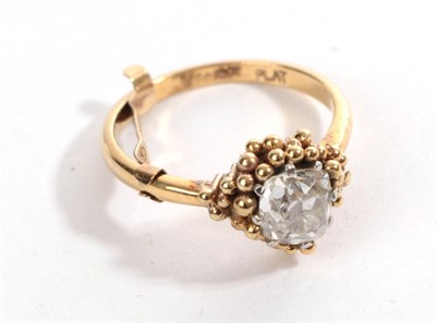 Lot 31 - A Diamond Solitaire Ring, the old cushion cut diamond in white claws, within an asymmetric...