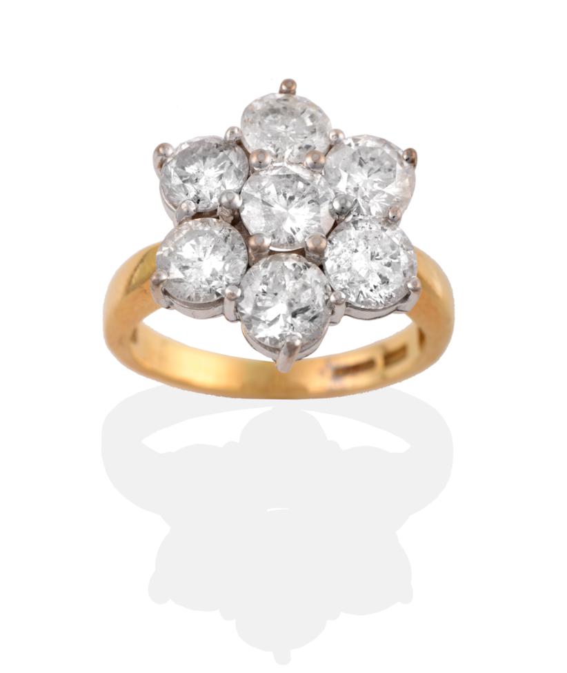 Lot 36 - An 18 Carat Gold Diamond Cluster Ring, seven round brilliant cut diamonds in white claw...