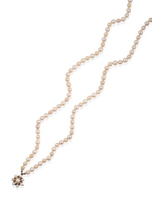 Lot 40 - A Two Row Cultured Pearl Necklace, the 59:63 pearls knotted to a clasp comprised of a central...