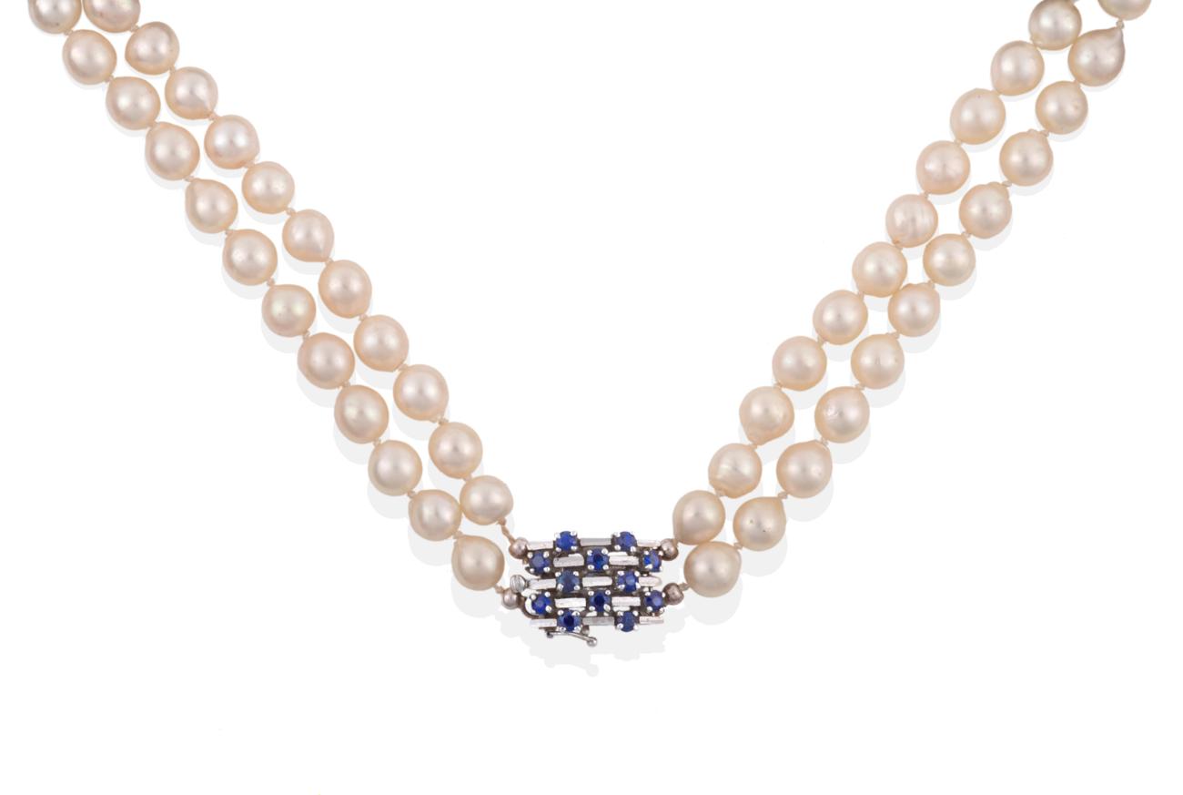 Lot 46 - A Two Row Cultured Pearl Necklace, the 45:49 pearls knotted to an oblong clasp set with...
