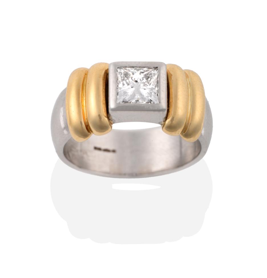 Lot 49 - A Contemporary Platinum Diamond Solitaire Ring, the princess cut diamond in a rubbed over...