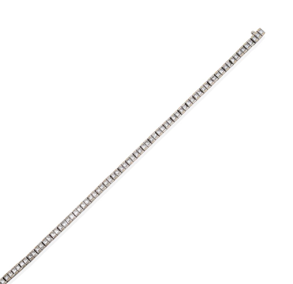 Lot 62 - An 18 Carat White Gold Diamond Line Bracelet, of princess cut diamonds in articulated white...