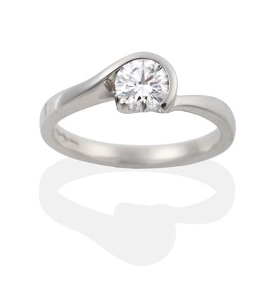 Lot 64 - A Platinum Diamond Solitaire Ring, the round brilliant cut diamond in a swirl setting to offset...
