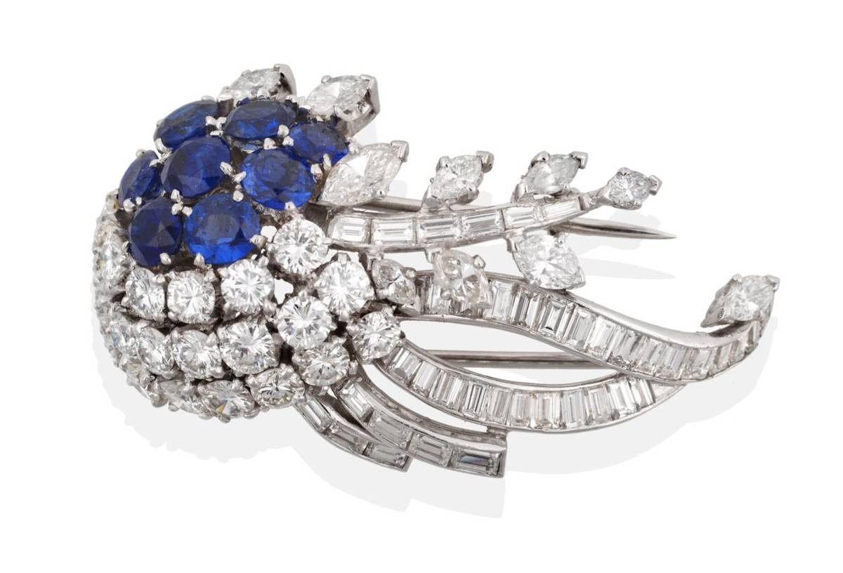 Lot 70 - A Diamond and Sapphire Brooch, circa 1950, of stylised floral form set with round cut...