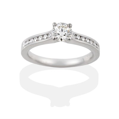 Lot 72 - A Platinum Diamond Ring, the round brilliant cut diamond in a four claw setting, to shoulders inset