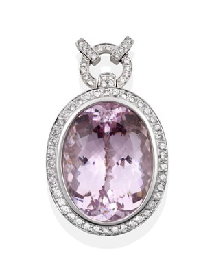 Lot 81 - A Kunzite and Diamond Pendant, the oval cut kunzite in a white rubbed over setting within a...