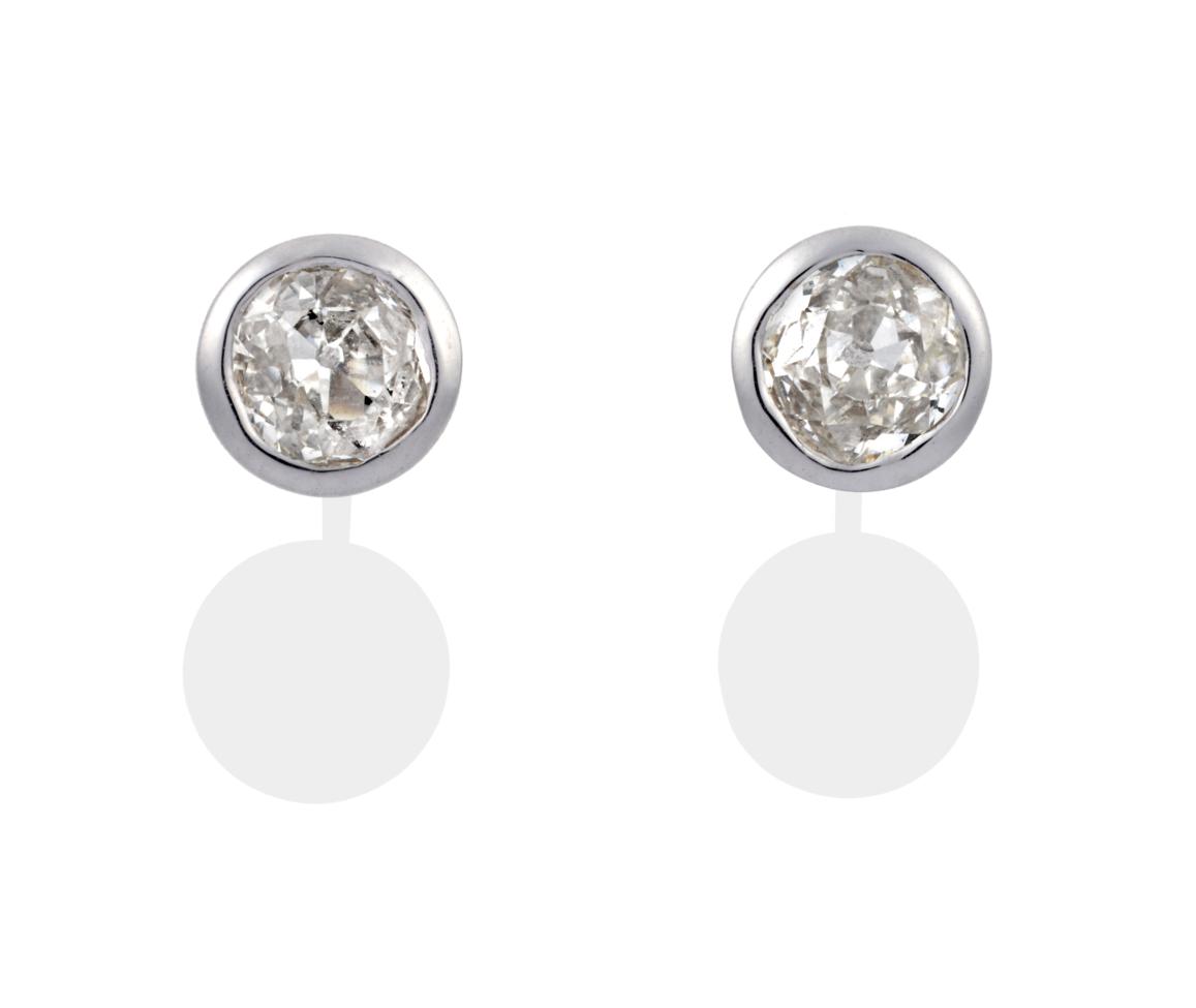 Lot 84 - A Pair of 18 Carat White Gold Diamond Solitaire Earrings, the old cut diamonds in rubbed over...