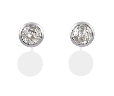 Lot 84 - A Pair of 18 Carat White Gold Diamond Solitaire Earrings, the old cut diamonds in rubbed over...