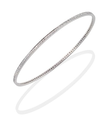 Lot 86 - An 18 Carat White Gold Diamond Bangle, inset throughout with round brilliant cut diamonds,...