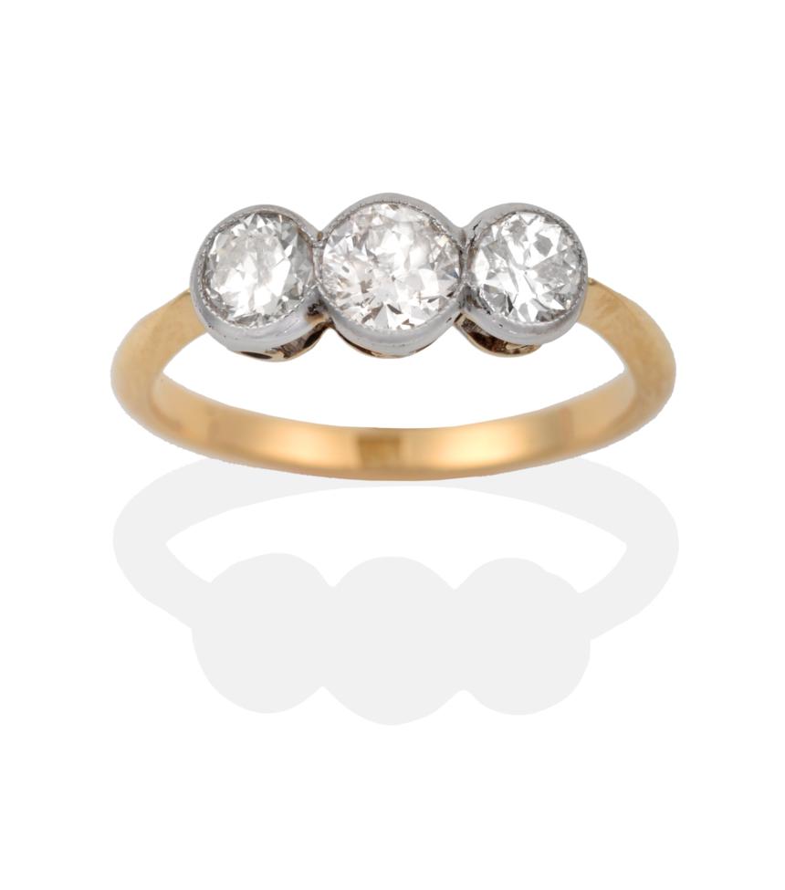 Lot 94 - A Diamond Three Stone Ring, the graduated old cut diamonds in white millegrain settings to...