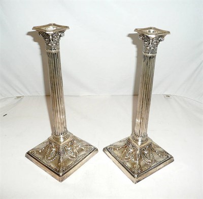 Lot 1092 - A Pair of Victorian Corinthian Column Candlesticks, Sheffield 1899, on swept square bases with...