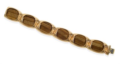 Lot 98 - An 18 Carat Gold Tiger's-Eye Bracelet, six oval panels in raised frames, length 18.5cm see...