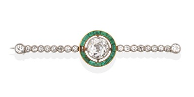 Lot 101 - A Diamond and Emerald Bar Brooch, an old cut diamond in a white millegrain setting, spaced to a...