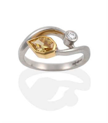 Lot 107 - A Platinum Yellow and White Diamond Ring, in a crossover style, a yellow Empress cut diamond in...