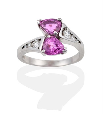 Lot 108 - An 18 Carat White Gold Pink Sapphire and Diamond Crossover Ring, two pear cut sapphires create...