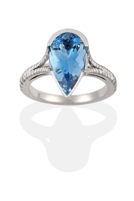 Lot 110 - An Aquamarine and Diamond Ring, a pear cut aquamarine in a white semi-rubbed over setting to forked