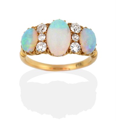 Lot 118 - A Late 19th Century Opal and Diamond Ring, three graduated oval cabochon opals spaced by vertically