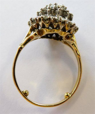 Lot 127 - A Diamond Cluster Ring, an oval cut diamond within a border of round brilliant cut diamonds and...