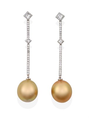 Lot 128 - A Pair of Diamond and Cultured South Sea Pearl Drop Earrings, a diamond bar comprised of a princess