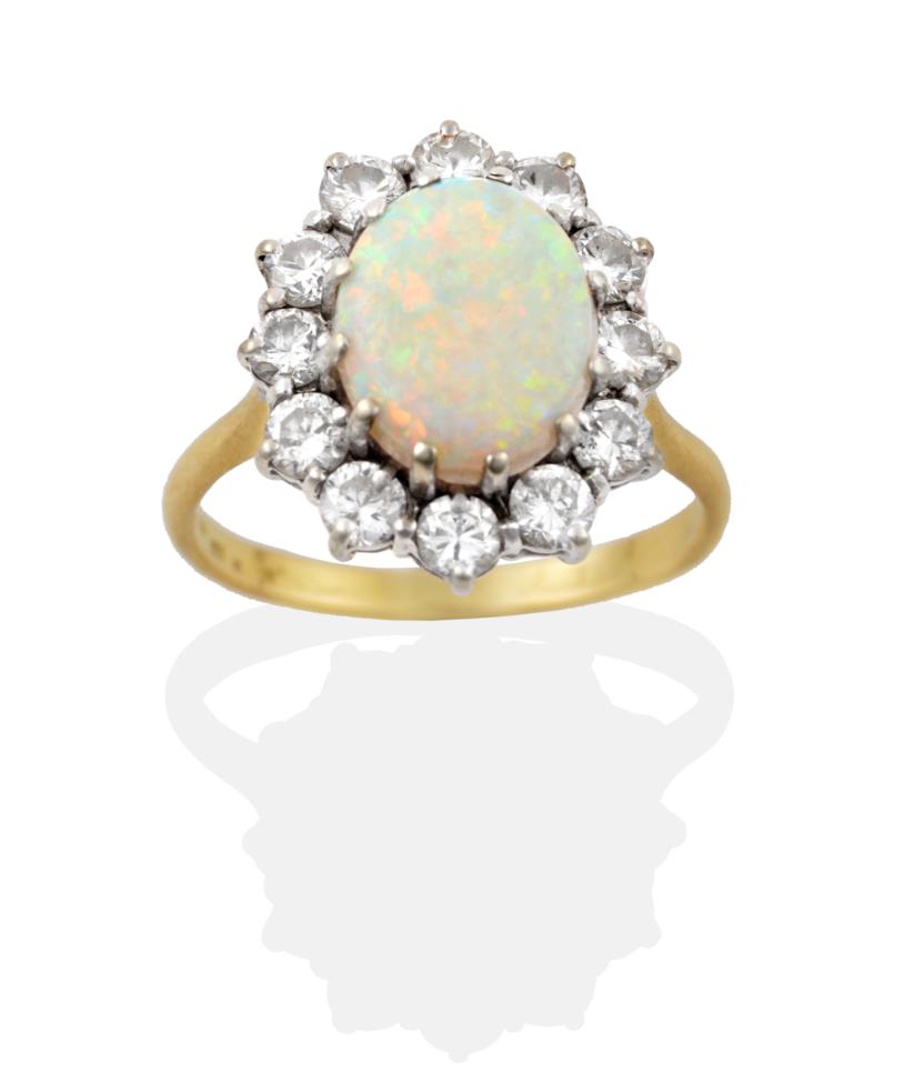 Lot 133 - An Opal and Diamond Cluster Ring, an oval cabochon opal in a white claw setting, within a border of