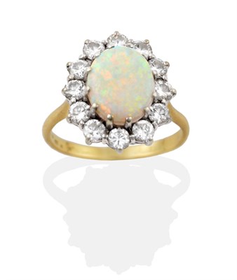 Lot 133 - An Opal and Diamond Cluster Ring, an oval cabochon opal in a white claw setting, within a border of